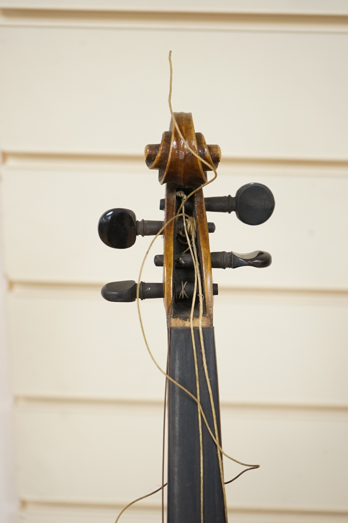 Three cased violins; a German Dresden violin, supplied by Campbell and co., Glasgow, together with another Dresden Stradivarius copy, and the remains of a European violin.